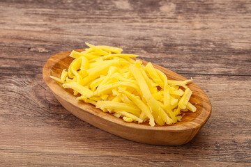 Shredded yellow cheese in the bowl