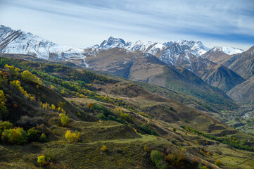 Mountain landscape with snow-capped peaks against the blue sky