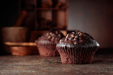 Chocolate muffins on a brown background.