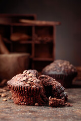 Chocolate muffins on a brown background.