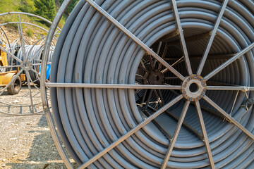 Spool of conduit at a worksite by the side of the road
