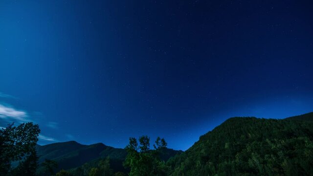 A sky full of stars and flowing clouds in the summer night sky of the Norikura Plateau  in Nagano, Japan