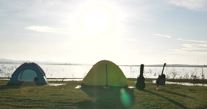 Beautiful camping site with lakes, tents, guitars, grasslands,camping with nature concept