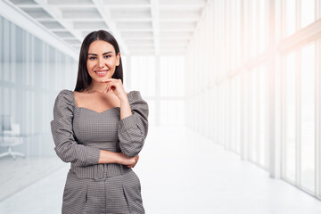 Portrait of smiling European attractive brunet woman in formal t