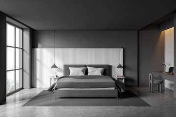 Grey bedroom interior with bed on concrete floor, window and workplace