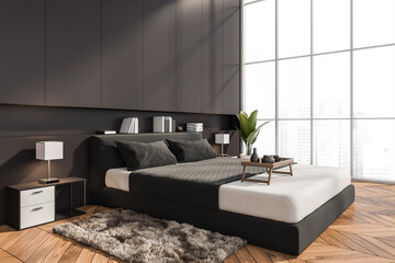 Corner of stylish grey bedroom with parquet floor