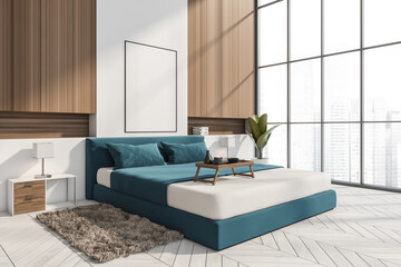Corner view of stylish blue and white bedroom with empty frame