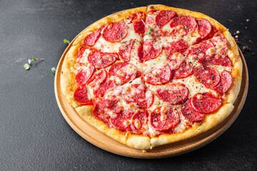 Pizza salami sausage pizza  pepperoni fast food cheese, tomato sauce, dough Takeaway fresh meal snack on the table copy space food background  pattern rustic 