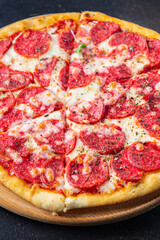 Pizza salami sausage pizza  pepperoni fast food cheese, tomato sauce, dough Takeaway fresh meal snack on the table copy space food background  pattern rustic 