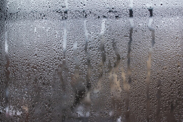 Misted glass. Rain outside the window. Water paths. For the background.