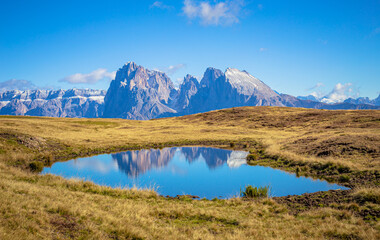 Dolomites reflection, view from Seiser Alm to Sella moutain range with Plattkofel and Langkofel
