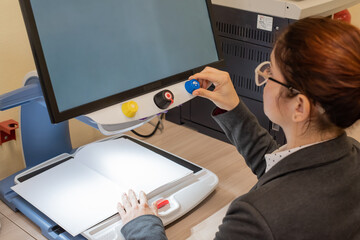 A visually impaired woman uses special reading equipment