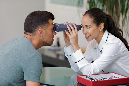 female optician checking eye sight