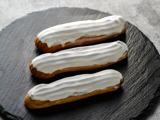 eclairs cakes on a black board