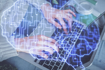 Double exposure of woman hands working on computer and brain hologram drawing. Ai concept.