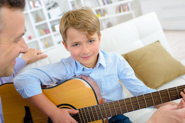 young boy playing a guitar