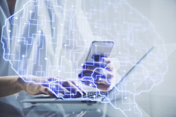 Double exposure of brain sketch hologram and woman holding and using a mobile device.