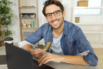 handsome man smiling while buying online