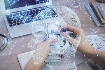 Multi exposure of brain drawing hologram and us dollars bills and man hands. Ai invest concept