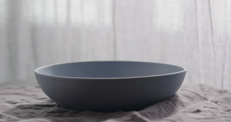 Empty blue bowl on linen napkin