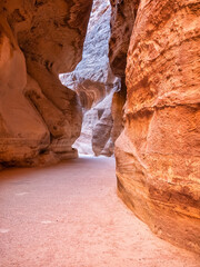 Picture with al-Siq, the natural passage through red rock walls which is main entrance to the ancient Nabatean city of Petra in southern Jordan.