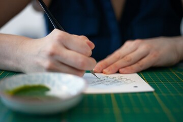 woman writing with caligraphy style