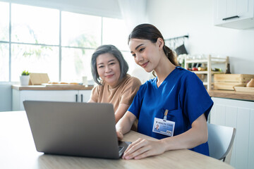 Asian nurse at nursing home take care of disabled senior elderly woman.