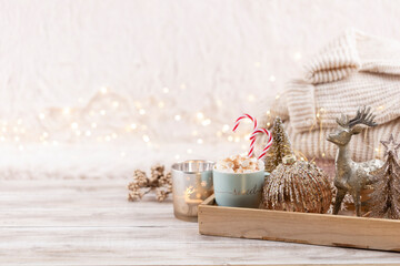 Cup with a hot drink, marshmallow on a table with christmas decorations.