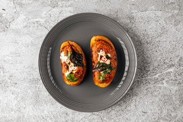 Two delicious bruschettas with eggplant aubergine spread on a plate