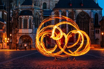 fire spinner creating shapes in front of cathedral