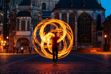 fire spinner creating shapes in front of cathedral