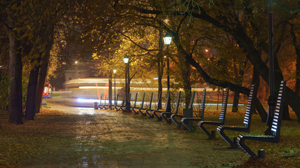 Long exposure photography of alley in the Mocow public park, Set of small benches for for...