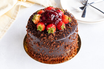 Strawberry and chocolate cake on a white background. Celebration cake filled with chocolate and strawberries