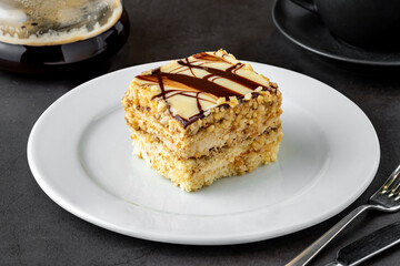 White chocolate and hazelnut cake on dark stone table