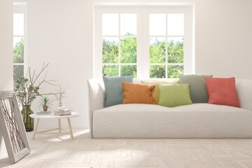 Fototapeta premium White living room with sofa and summer landscape in window. Scandinavian interior design. 3D illustration