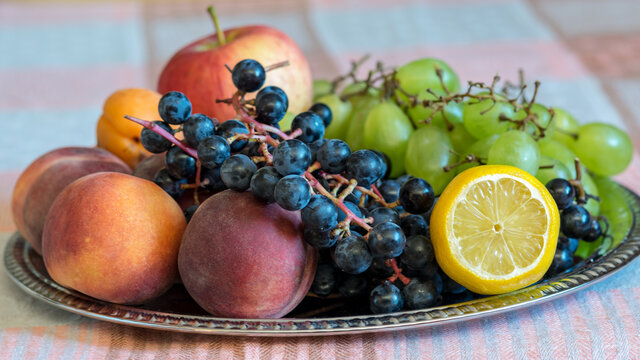 fruit fragments on a metal tray, grapes, plums, peaches, apricots, autumn harvest time, healthy diet and vitamins, autumn