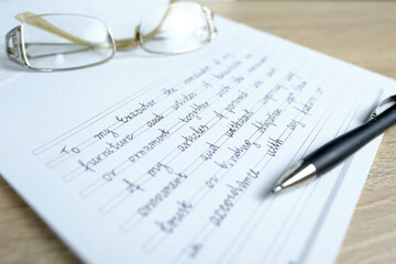close-up of glasses and a ballpoint pen on paper with a written will, the concept of a legal order...