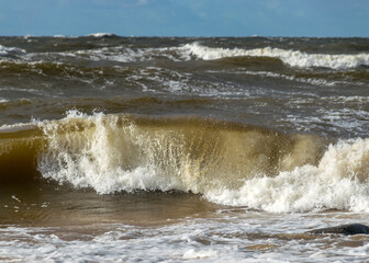 wave on the beach, background blur and waves in sunlight, dramatic natural background, waves and splashes of water, Vidzeme rocky seashore, Salacgriva rural area, Latvia