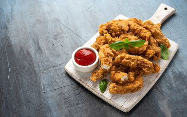 Fried Chicken strips with ketchup on white wooden board. Fast Food