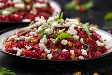 Bulgur salad with beetroot, walnuts, arugula and feta cheese. Healthy diet food