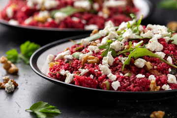 Bulgur salad with beetroot, walnuts, arugula and feta cheese. Healthy diet food