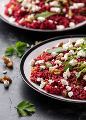 Bulgur salad with beetroot, walnuts, arugula and feta cheese. Healthy diet food