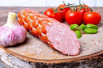 Homemade sausage sausage on a cutting board made of birch wood