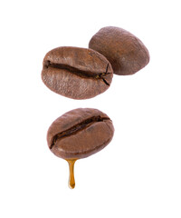 coffee beans with coffee dripping isolated on white