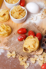Fototapeta premium Traditional italian pasta on brown background. Food photo top view. Italian cuisine.