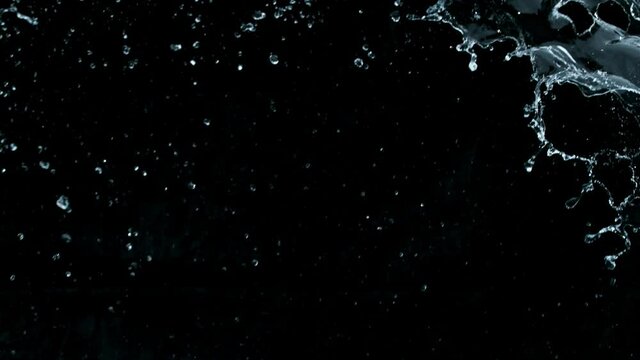 Super slow motion of big water splash on black background. Filmed on high speed cinema camera, 1000 fps.
