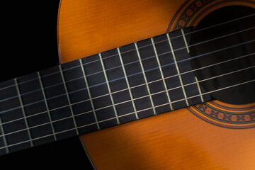 Guitar close up detail on black background. Perfect for flyer, card, poster or wallpaper