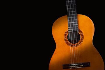 Obraz premium Guitar on black background. Classic acoustic guitar concept. Perfect for flyer, card, poster or wallpaper