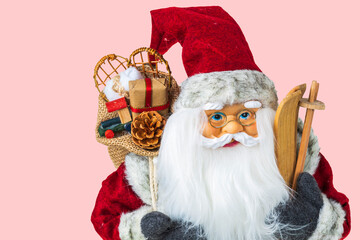 Close up view of a cute figure of Santa Claus with skis and a bag of gifts behind his back. Sweden.