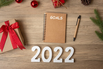 2022 GOAL with notebook, Christmas gift and pen on wood table. Xmas, Happy New Year, Resolution, To do list, start, Strategy and Plan concept